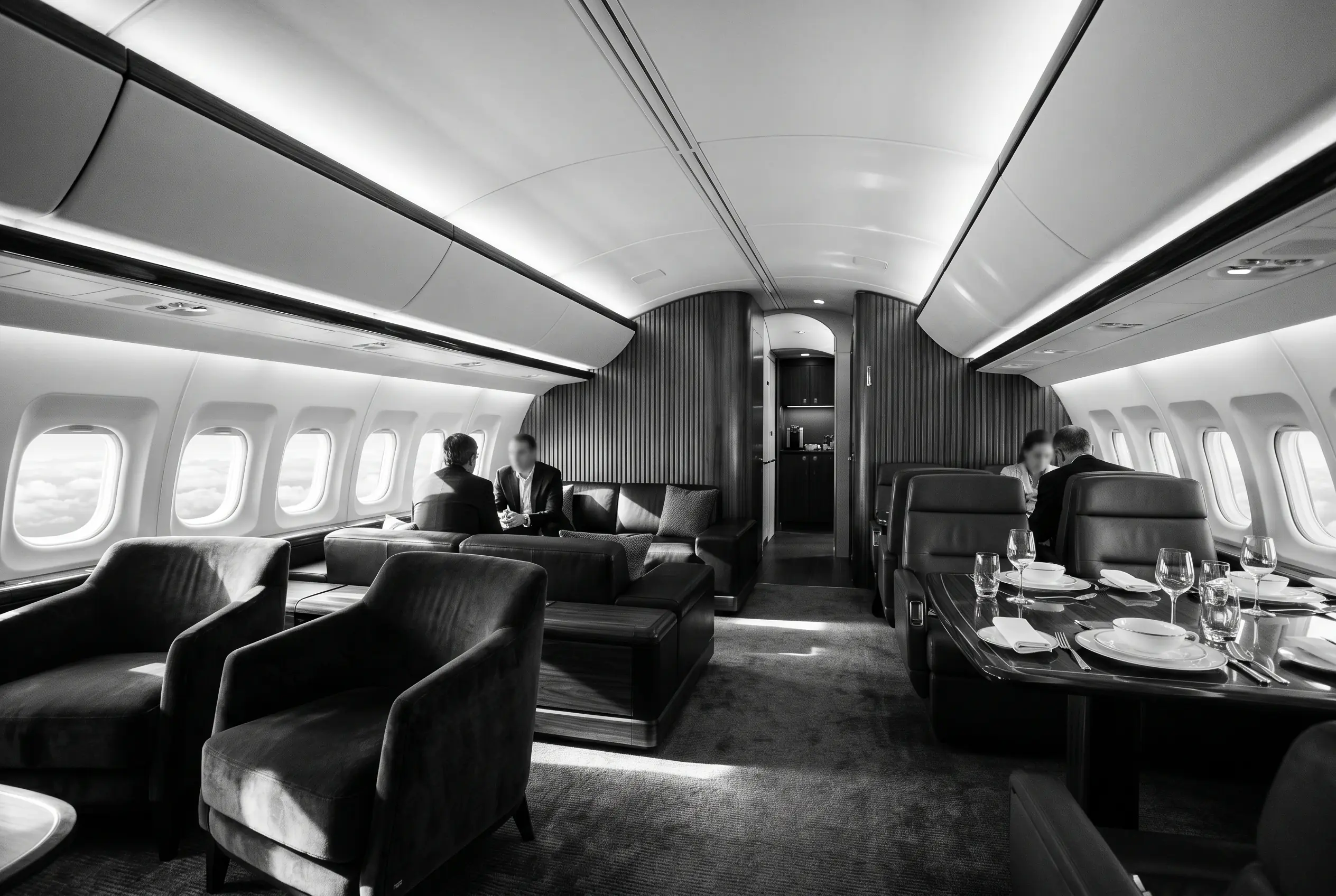 Boeing BBJ MAX 8 VIP lounge and dining area for a New York to Miami charter, in black and white
