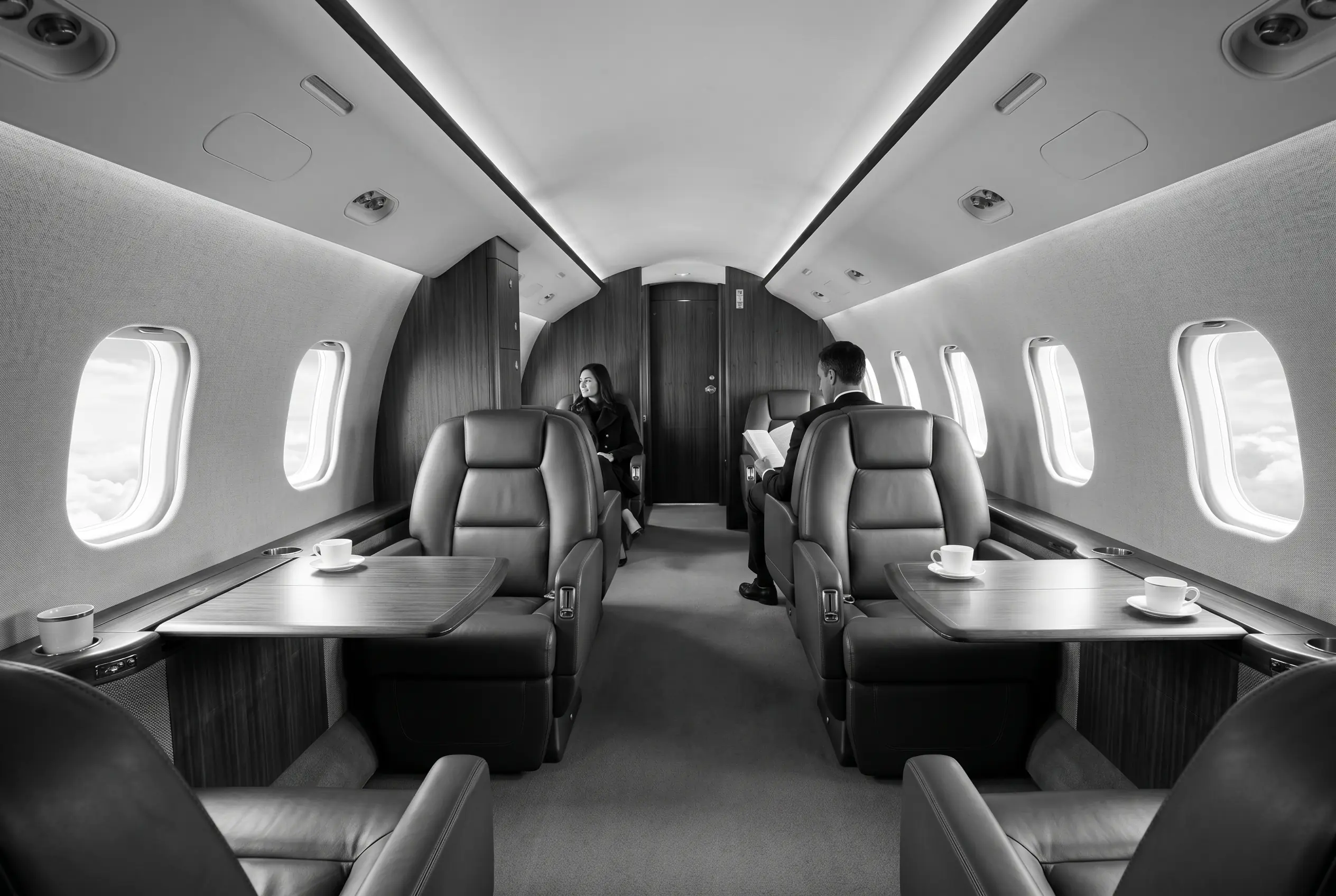 Bombardier Challenger 350 wide flat-floor cabin for a New York to Miami charter, in monochrome