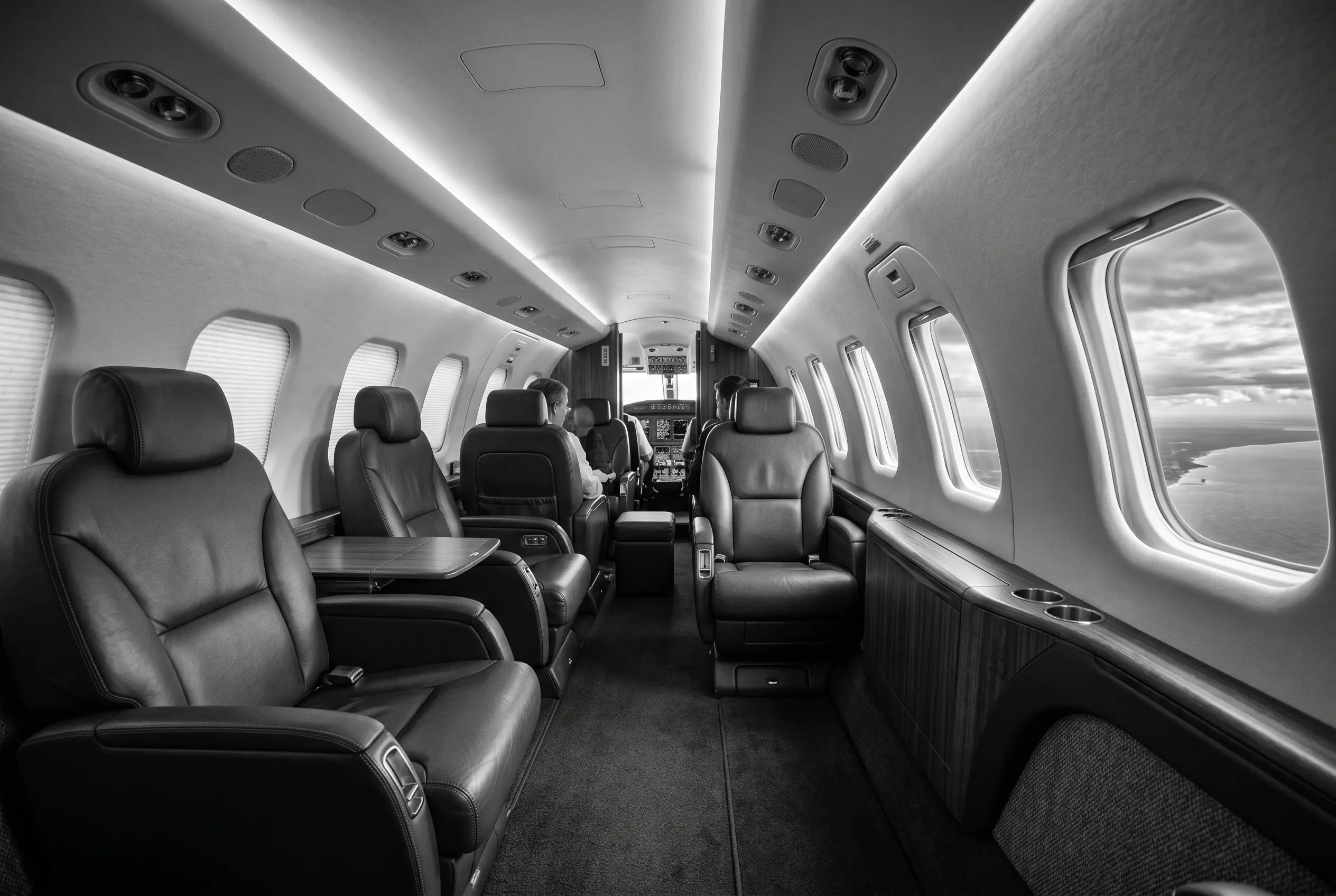 Cessna Citation Latitude flat-floor cabin for a New York to Miami charter, in monochrome