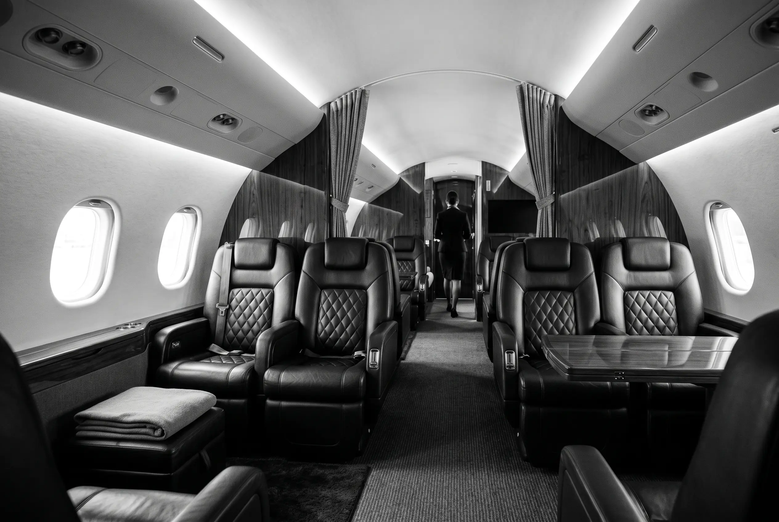 Dassault Falcon 900LX cabin for a New York to Miami charter, in black and white