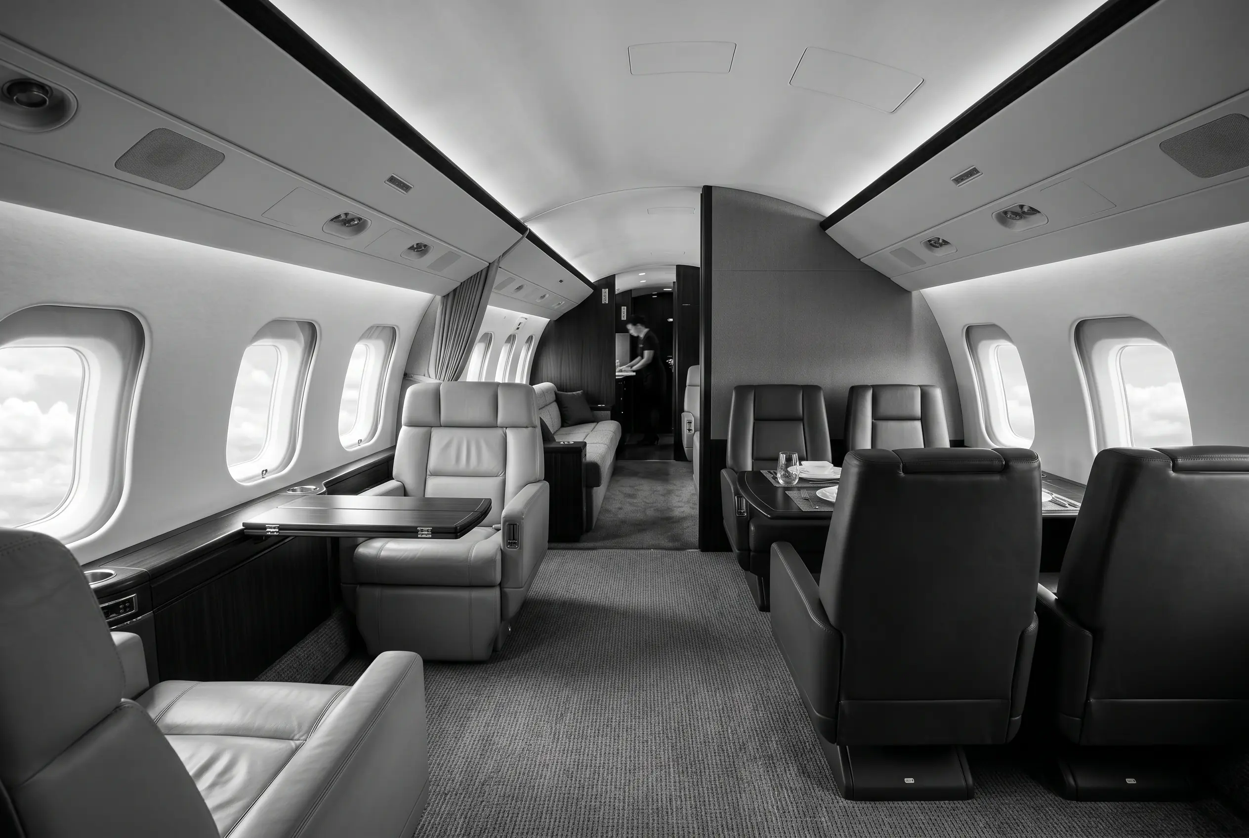 Bombardier Global 6500 large cabin with three living zones for a New York to Miami charter, in monochrome