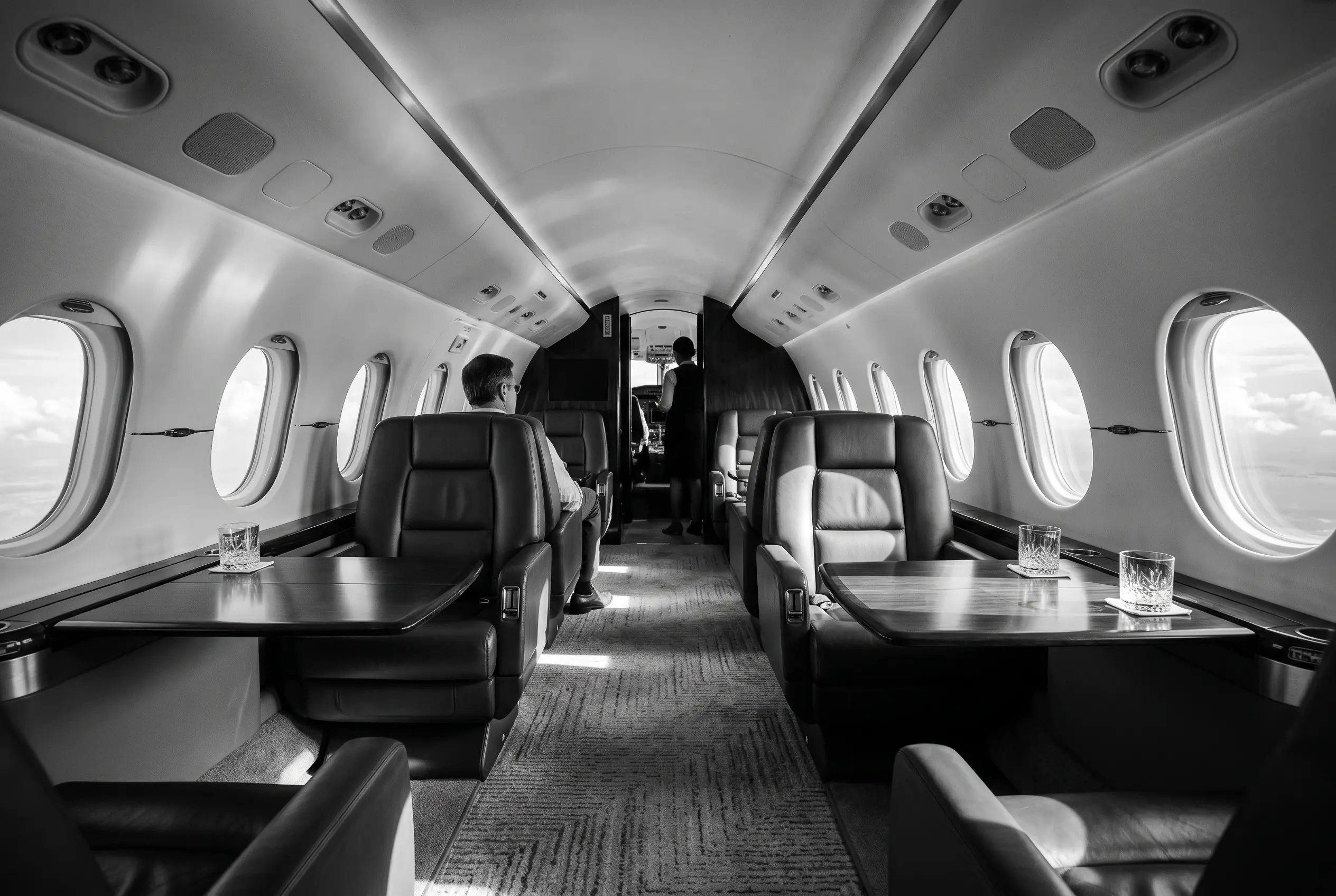 Gulfstream G280 wide flat-floor cabin for a New York to Miami charter, in monochrome
