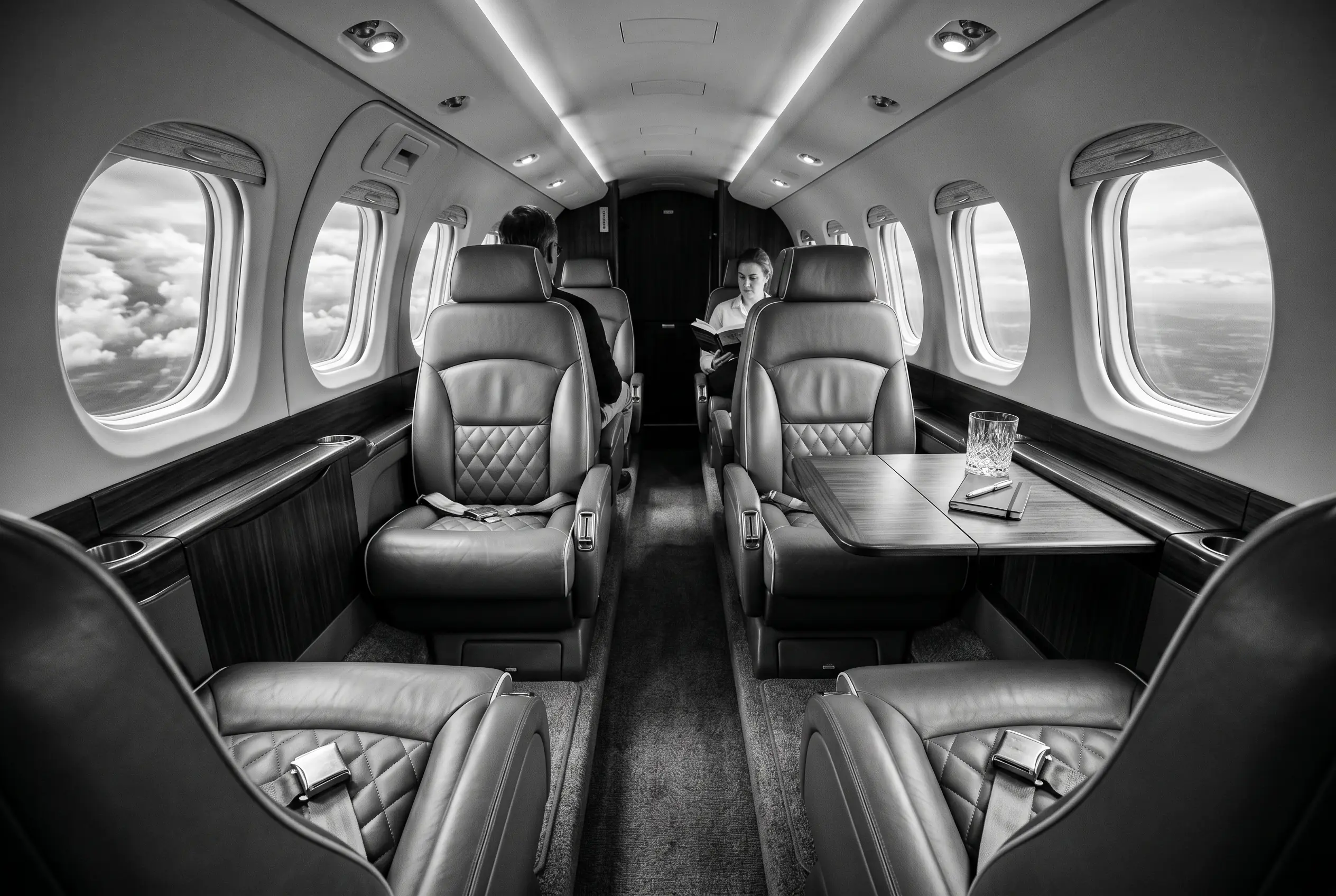 Beechcraft King Air 260 club cabin for a New York to Miami charter, in black and white