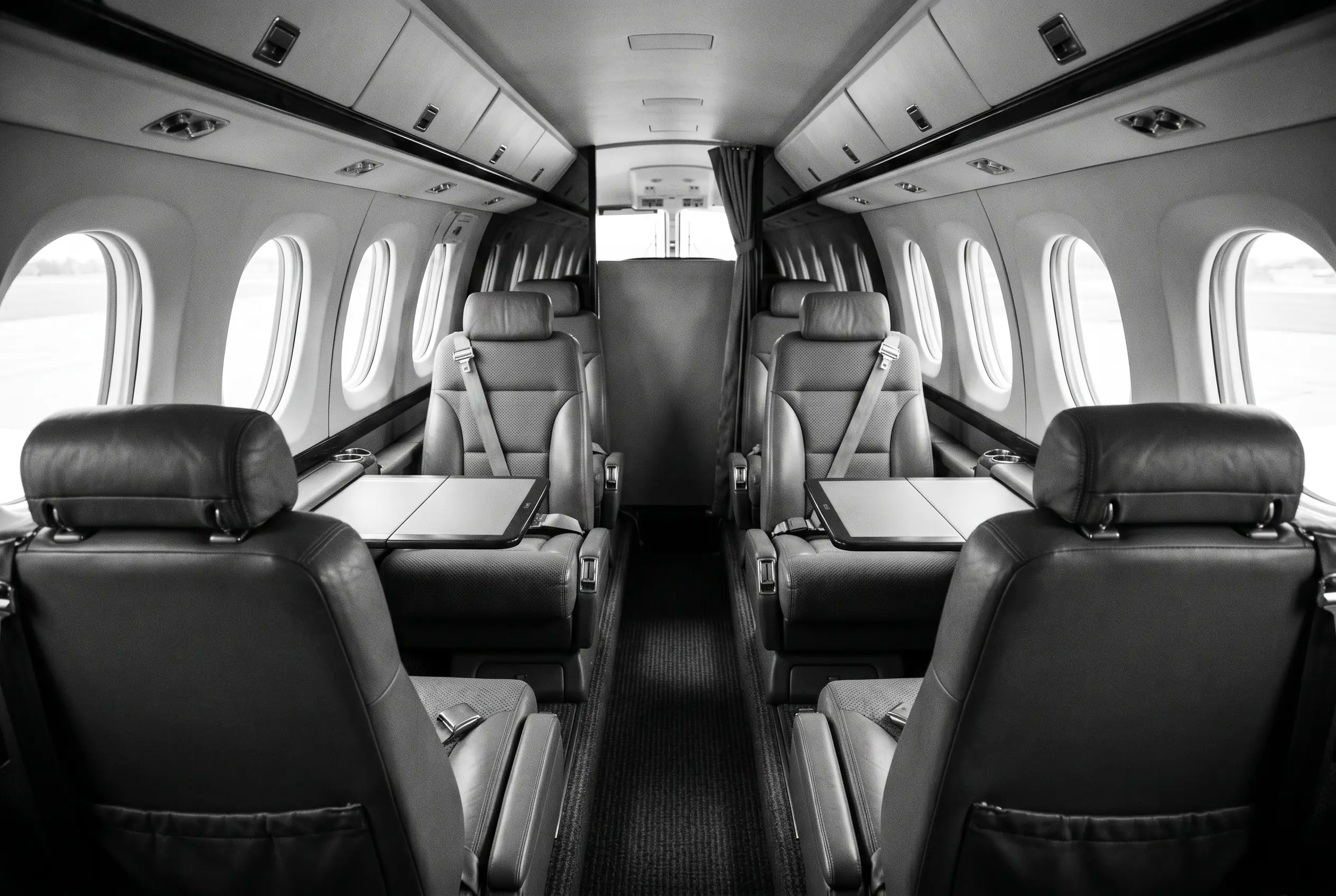 Beechcraft King Air C90GTx cabin for a New York to Miami charter, in monochrome