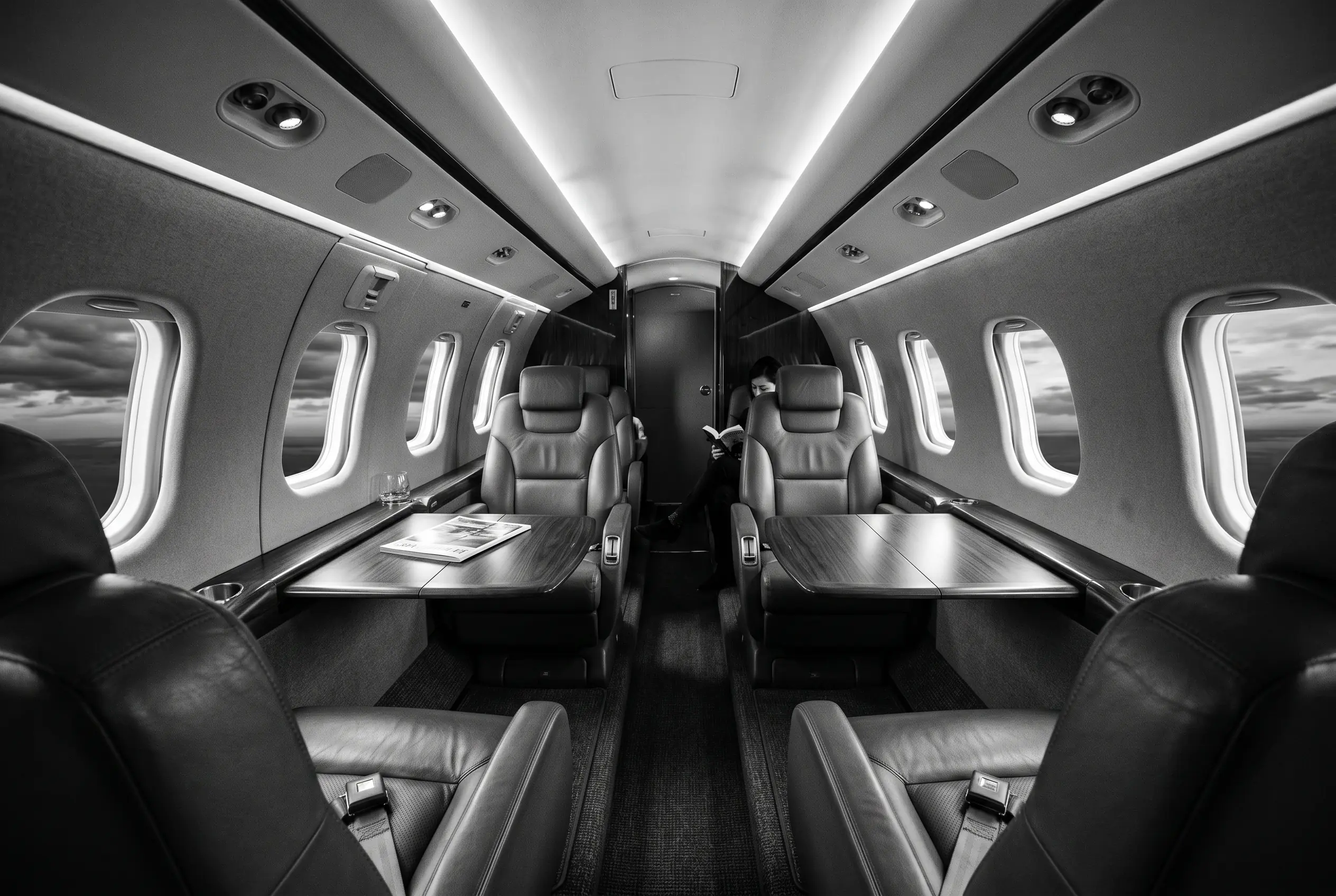 Bombardier Learjet 75 double-club cabin for a New York to Miami charter, in monochrome