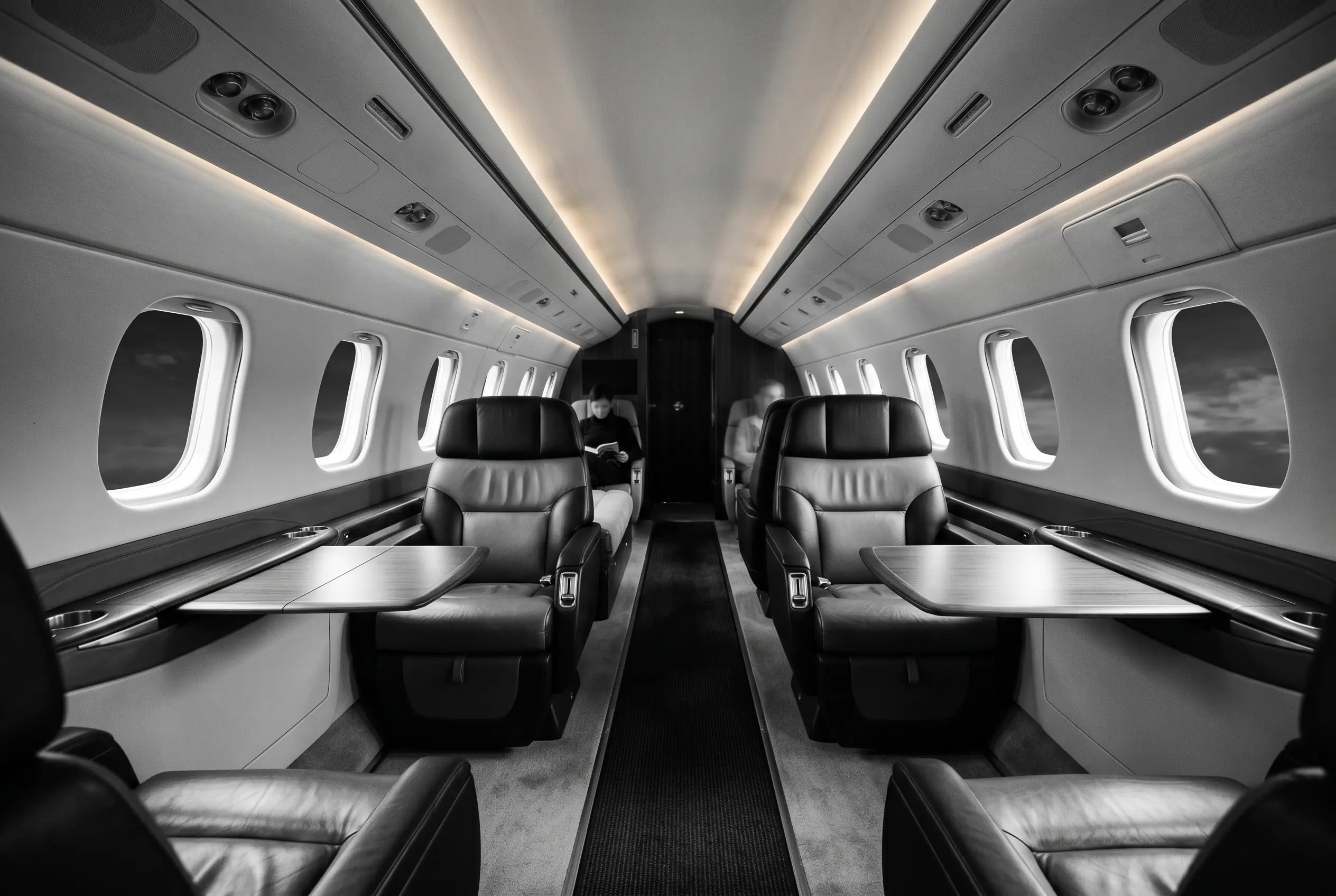 Embraer Legacy 500 flat-floor cabin for a New York to Miami charter, in black and white