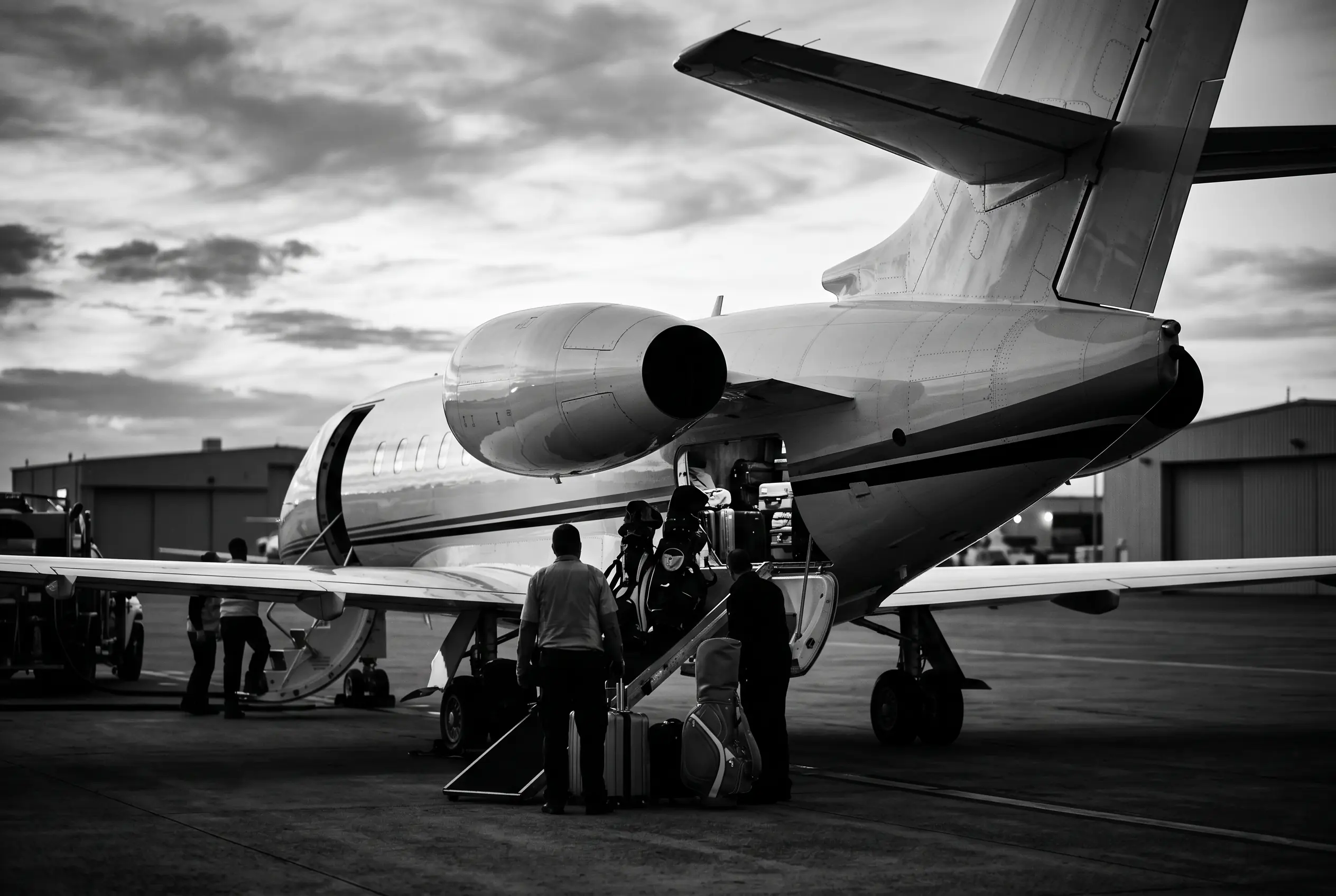 Golf clubs and beach luggage loaded into a private jet hold for a New York to Miami getaway