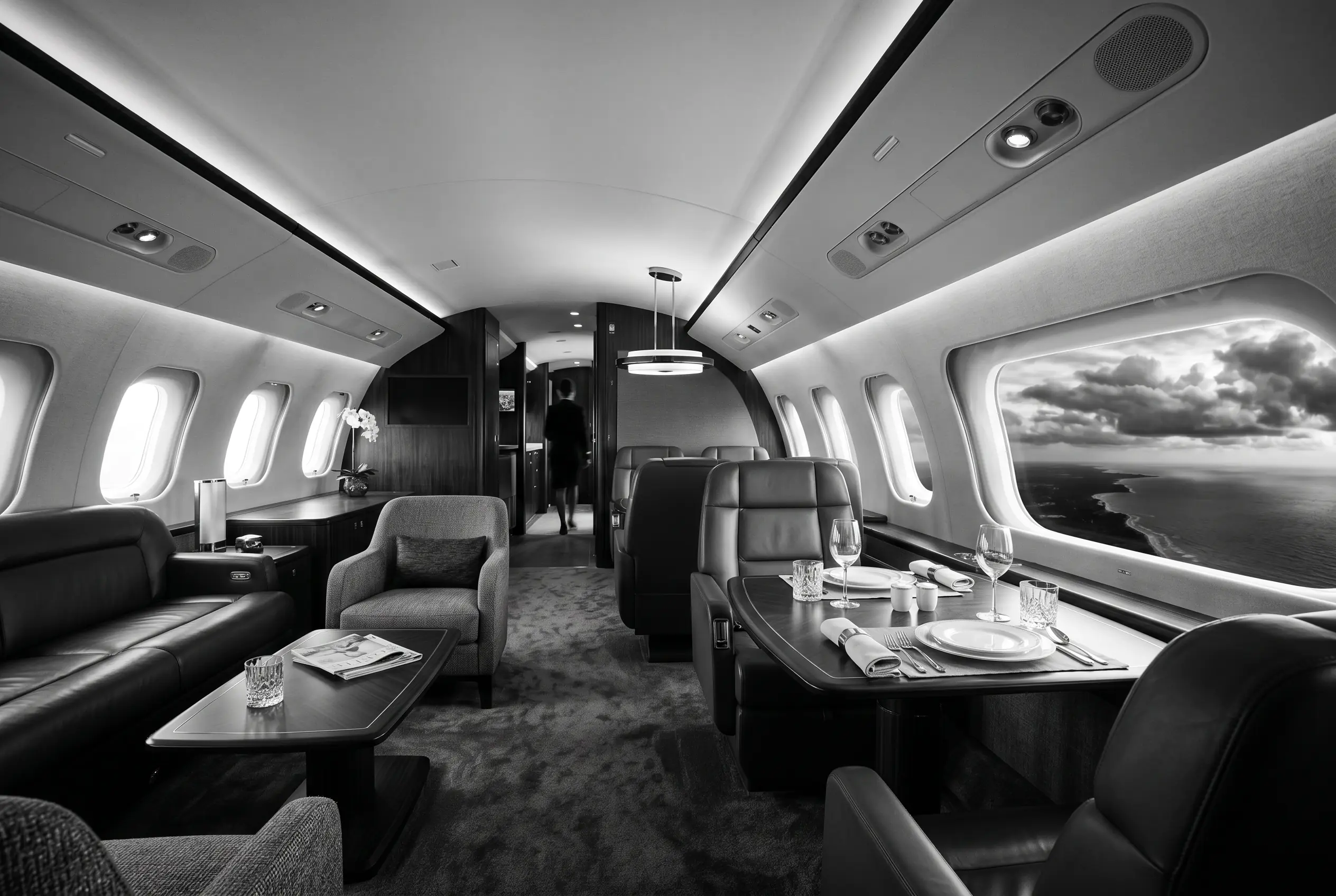 Embraer Lineage 1000E VIP lounge and dining area for a New York to Miami charter, in monochrome