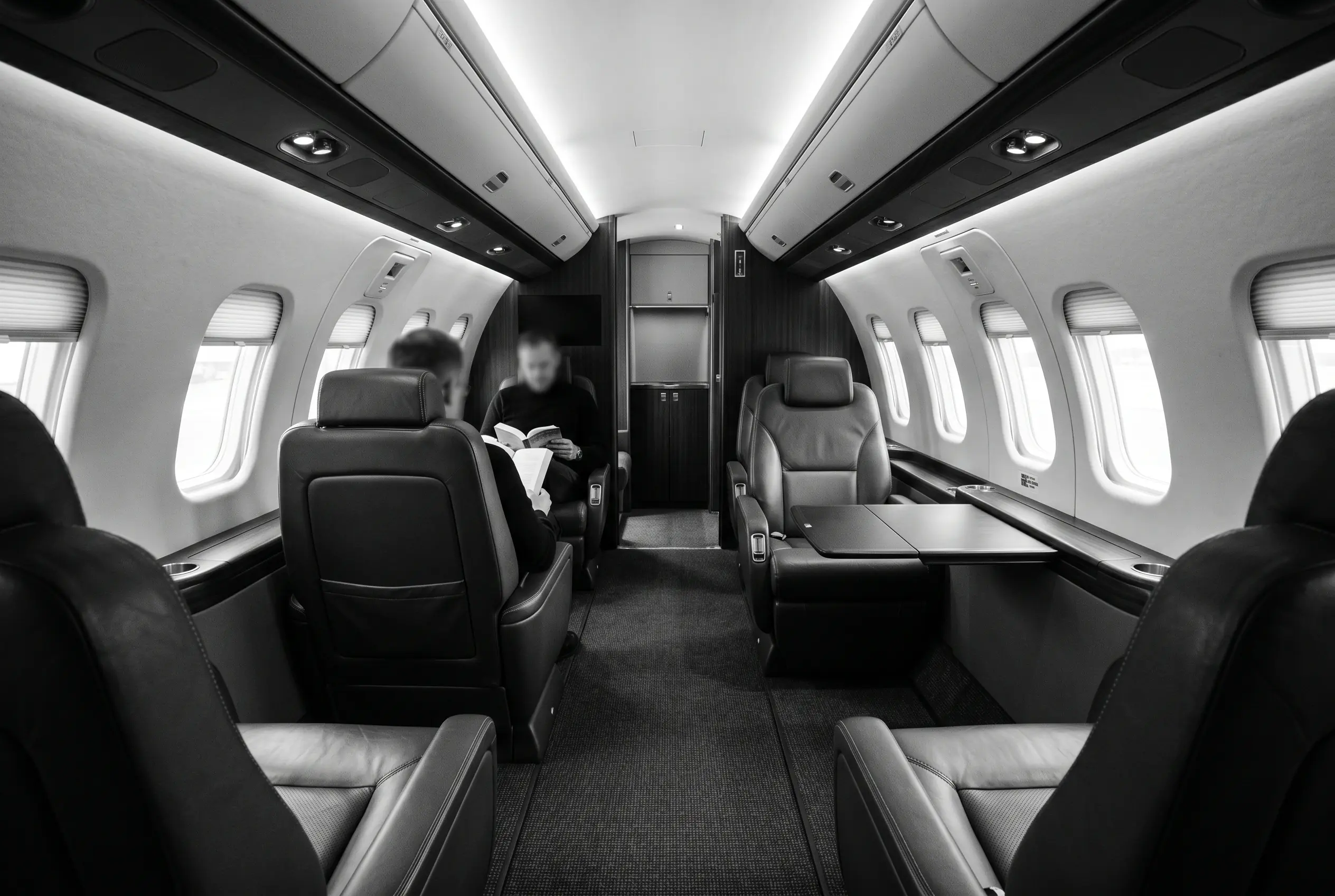 Pilatus PC-24 flat-floor cabin for a New York to Miami charter, in monochrome