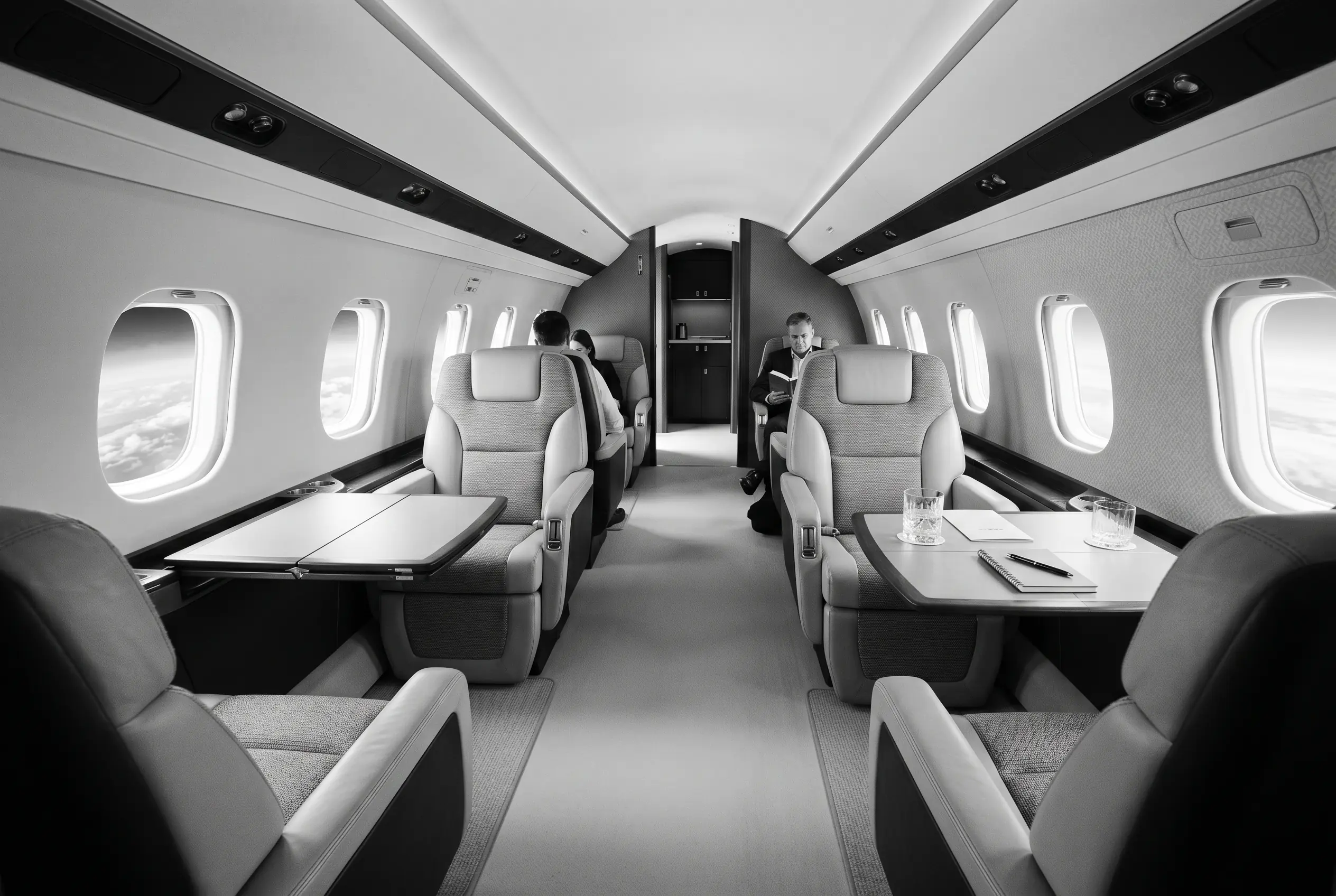 Embraer Praetor 500 flat-floor cabin for a New York to Miami charter, in monochrome
