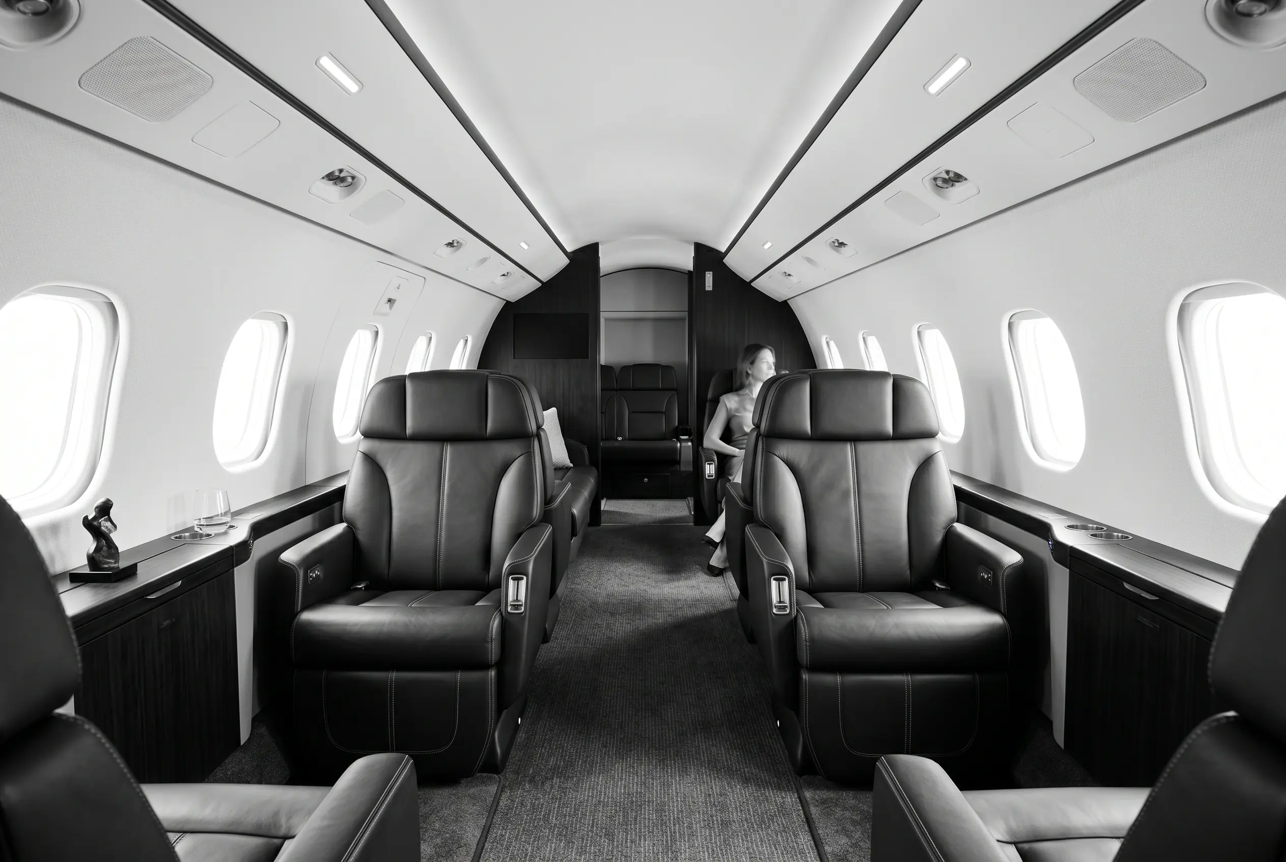 Embraer Praetor 600 flat-floor cabin for a New York to Miami charter, in monochrome