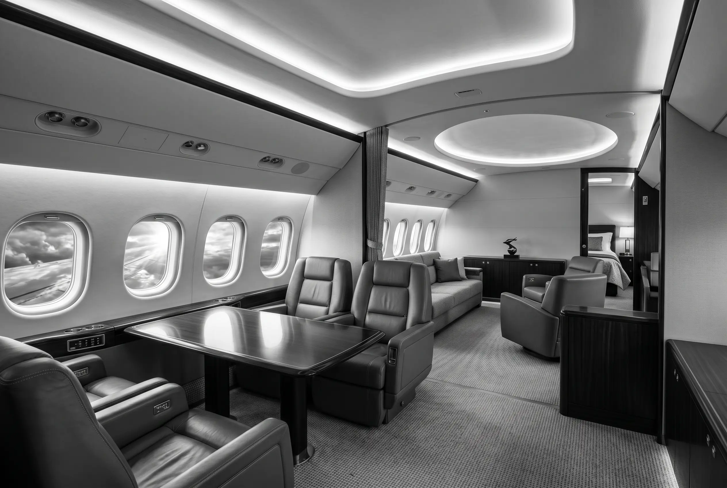 Ultra-long-range jet cabin with multiple living zones for a New York to Miami charter, in monochrome